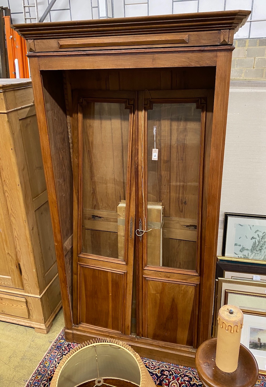 An early 20th century French glazed cherry two door bookcase, width 116cm, depth 48cm, height 212cm